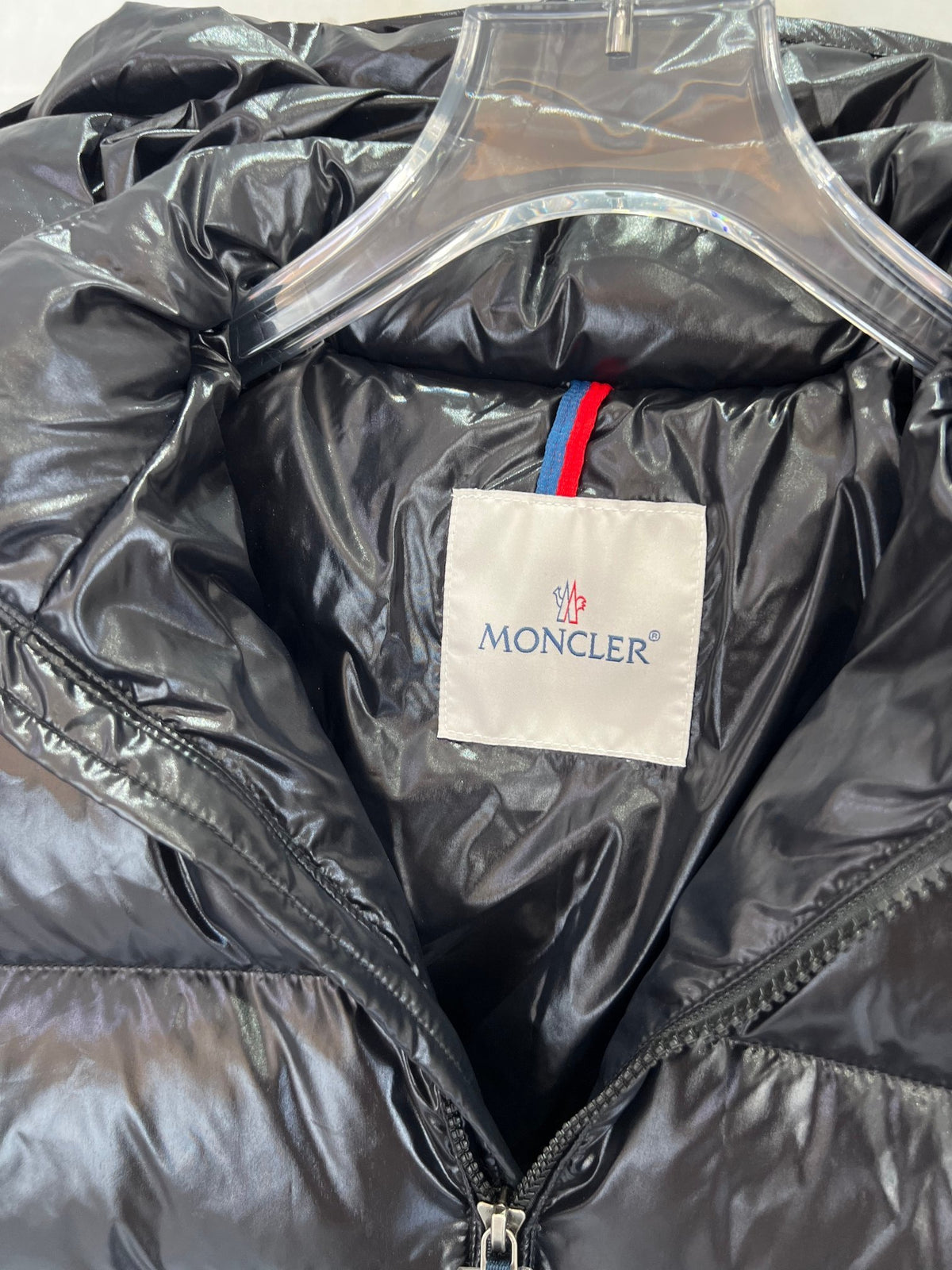 Moncler Black Classic Down Hooded Jacket – High-Gloss Lacquered Shell Wide Baffles Integrated Hood Comic-Strip Label Moncler Outerwear