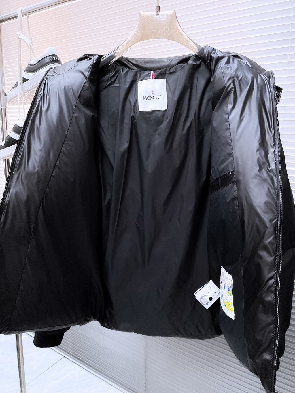 Moncler Matt Black Edition Down Jacket – Graphic Back Logo Print High-Gloss Shell Wide Baffles Oversized Hood Drawstring Waist Strap Cuffs Moncler Outerwear