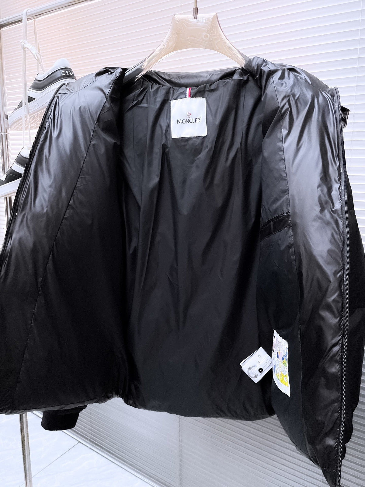 Moncler Matt Black Edition Down Jacket – Graphic Back Logo Print High-Gloss Shell Wide Baffles Oversized Hood Drawstring Waist Strap Cuffs Moncler Outerwear
