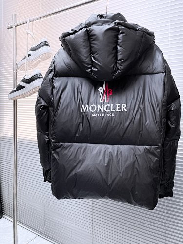 Moncler Matt Black Edition Down Jacket – Graphic Back Logo Print High-Gloss Shell Wide Baffles Oversized Hood Drawstring Waist Strap Cuffs Moncler Outerwear
