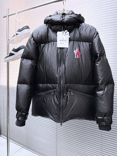 Moncler Matt Black Edition Down Jacket – Graphic Back Logo Print High-Gloss Shell Wide Baffles Oversized Hood Drawstring Waist Strap Cuffs Moncler Outerwear