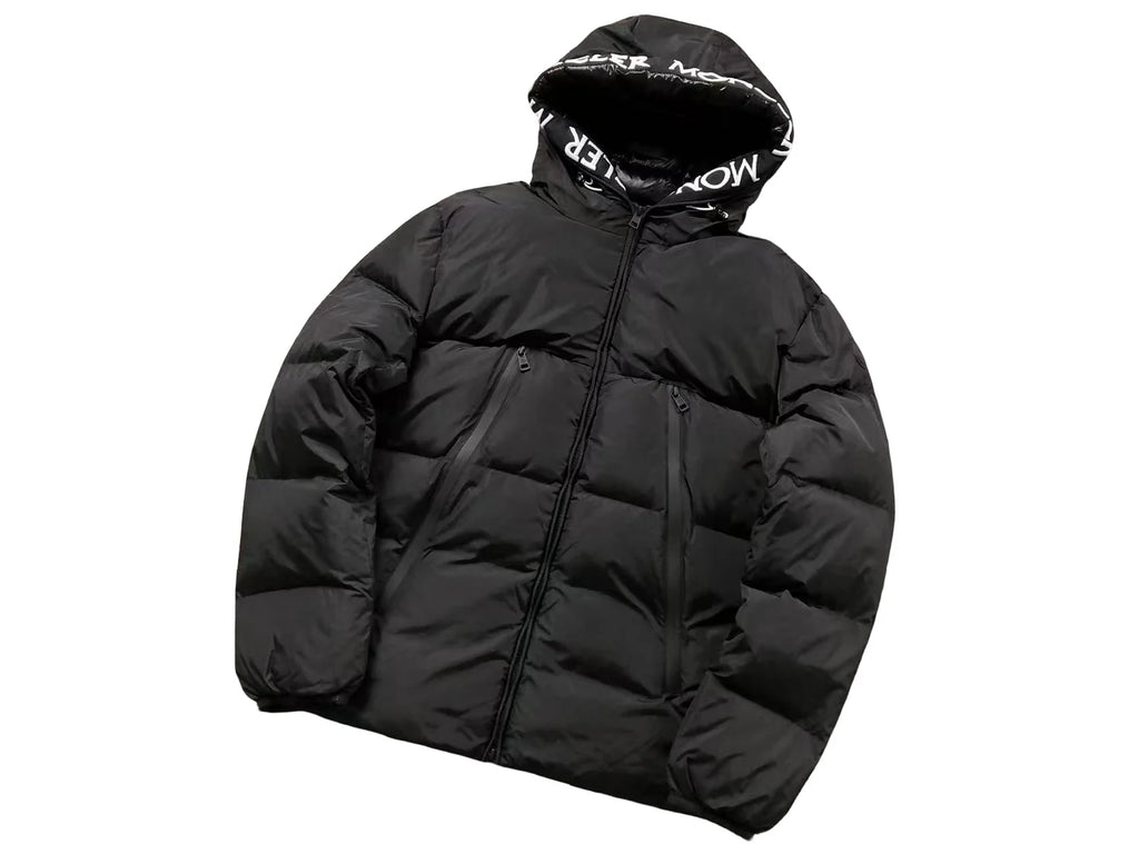 Moncler Black Oversized Down Jacket – All-Caps Logo Hood Brim Diagonal Baffles Matte Shell Chest Zip Pockets Comic-Strip Label Moncler Outerwear